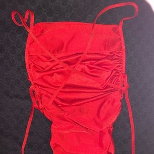very vibrant red Silky bodysuit, with open back cross strings to tie.